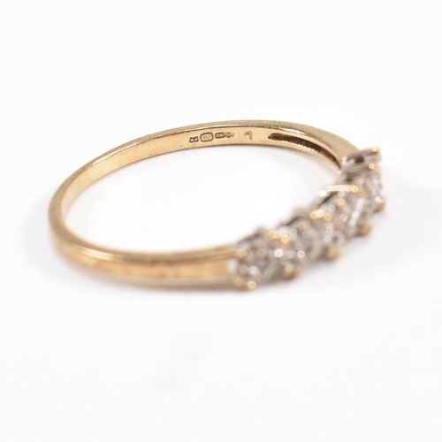 75 - Two hallmarked 9ct gold half hoop rings. A diamond set half hoop ring with star decoration and a sap... 