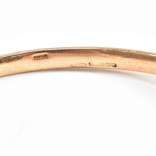 8 - A hallmarked 9ct gold snake bangle. The bangle in the form of a coiled snake. Hallmarked Birmingham.... 