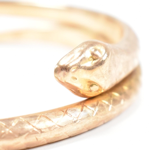 8 - A hallmarked 9ct gold snake bangle. The bangle in the form of a coiled snake. Hallmarked Birmingham.... 