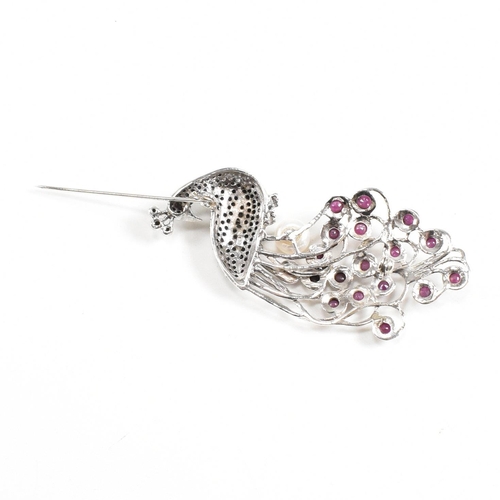 81 - A contemporary 925 silver marcasite peacock brooch set with garnets. Weight approx 16g. Measures app... 