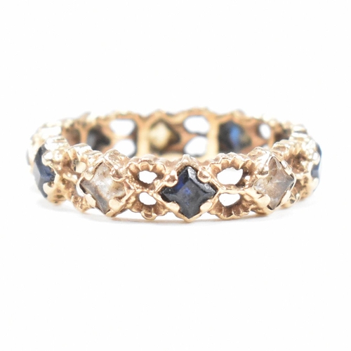 82 - A mid century gold sapphire and spinel eternity ring. Weight 2g. Unmarked tests indicate gold. Size ... 