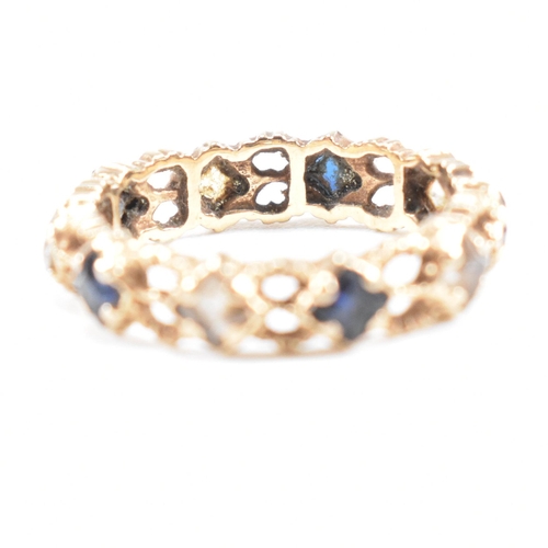 82 - A mid century gold sapphire and spinel eternity ring. Weight 2g. Unmarked tests indicate gold. Size ... 