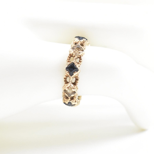 82 - A mid century gold sapphire and spinel eternity ring. Weight 2g. Unmarked tests indicate gold. Size ... 