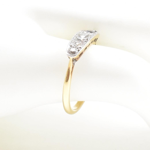 9 - A  gold and diamond five stone ring. The ring set with five graduating old cut diamonds to lozenge s... 