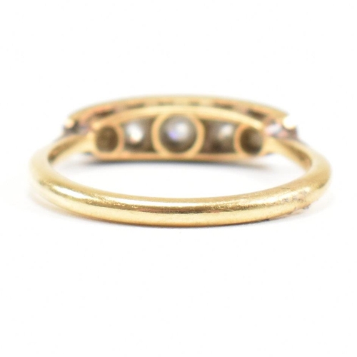 9 - A  gold and diamond five stone ring. The ring set with five graduating old cut diamonds to lozenge s... 