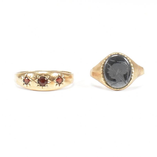 91 - Two 9ct gold rings. A hallmarked garnet set three stone ring and hematite signet ring. Weight 5.2g. ... 