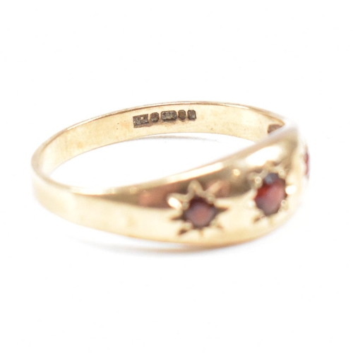 91 - Two 9ct gold rings. A hallmarked garnet set three stone ring and hematite signet ring. Weight 5.2g. ... 