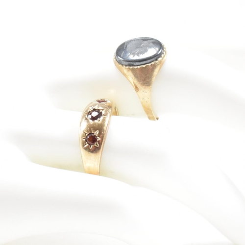 91 - Two 9ct gold rings. A hallmarked garnet set three stone ring and hematite signet ring. Weight 5.2g. ... 