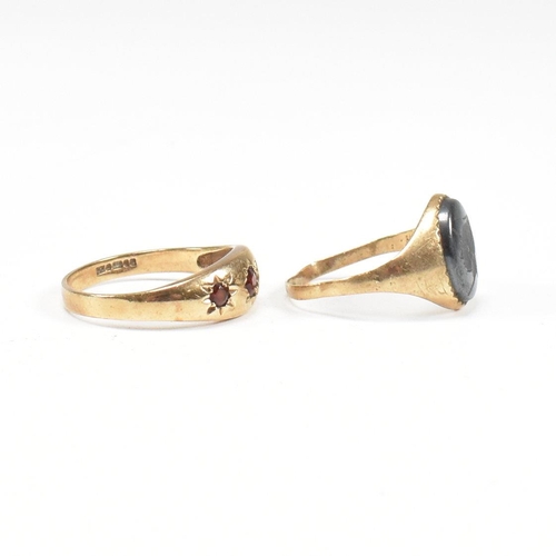 91 - Two 9ct gold rings. A hallmarked garnet set three stone ring and hematite signet ring. Weight 5.2g. ... 