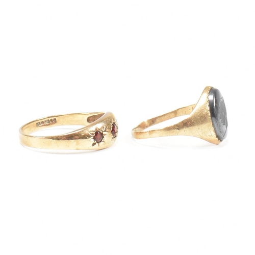 91 - Two 9ct gold rings. A hallmarked garnet set three stone ring and hematite signet ring. Weight 5.2g. ... 