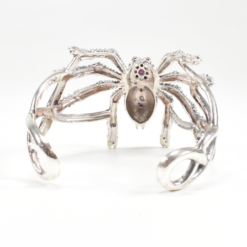 94 - A contemporary 925 silver marcasite and ruby spider cuff bangle. Stamped 925. Weight approx 38.3g. M... 