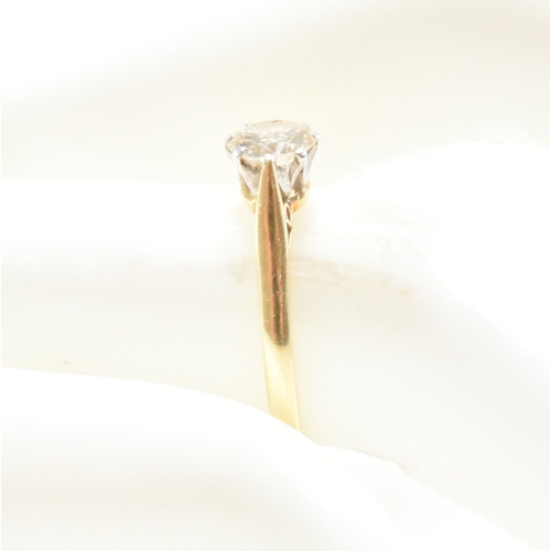 31 - A hallmarked 18ct gold and diamond solitaire ring. The ring set with a round brilliant cut diamond t... 