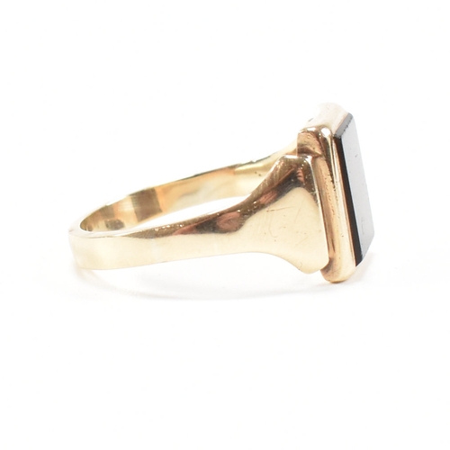 180 - A 9ct gold and sard signet ring. The ring set with rectangular sard plaque to a wide band shank. Unm... 