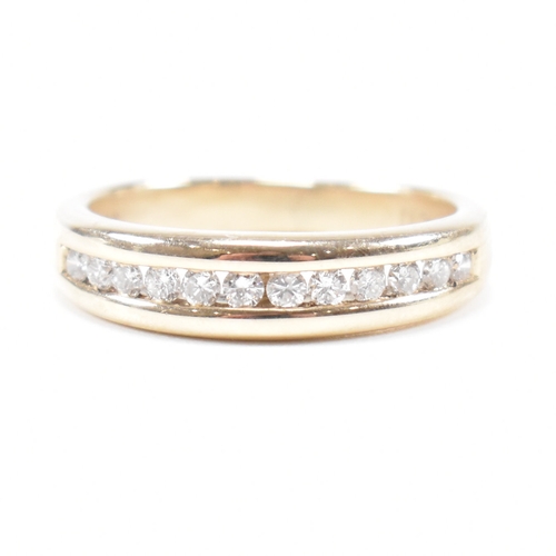 205 - A hallmarked 9ct gold and diamond half eternity ring. The ring set with twelve suspension set round ... 