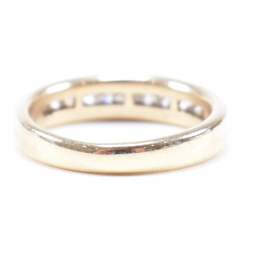 205 - A hallmarked 9ct gold and diamond half eternity ring. The ring set with twelve suspension set round ... 