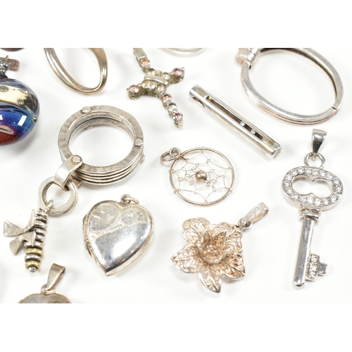 240 - An assorted collection of silver necklace pendants & charms. The lot to include a tubular pendant se... 