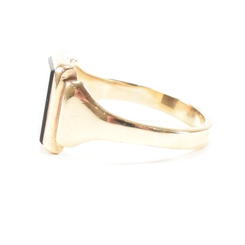 180 - A 9ct gold and sard signet ring. The ring set with rectangular sard plaque to a wide band shank. Unm... 