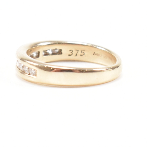 205 - A hallmarked 9ct gold and diamond half eternity ring. The ring set with twelve suspension set round ... 