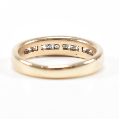 205 - A hallmarked 9ct gold and diamond half eternity ring. The ring set with twelve suspension set round ... 