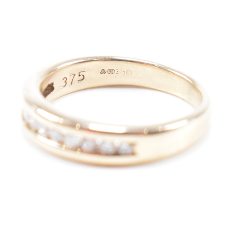 205 - A hallmarked 9ct gold and diamond half eternity ring. The ring set with twelve suspension set round ... 