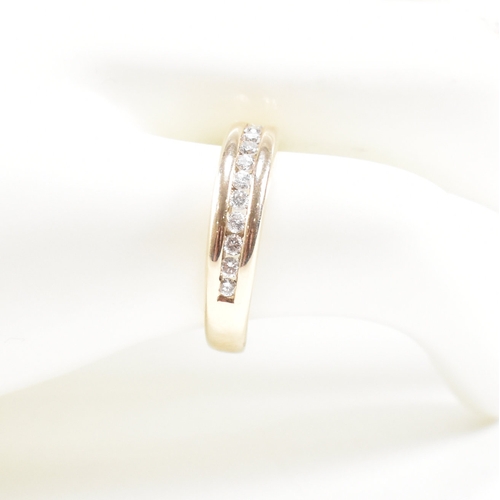 205 - A hallmarked 9ct gold and diamond half eternity ring. The ring set with twelve suspension set round ... 