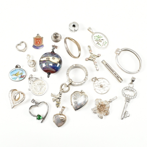 240 - An assorted collection of silver necklace pendants & charms. The lot to include a tubular pendant se... 