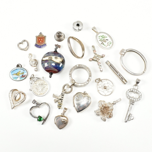 240 - An assorted collection of silver necklace pendants & charms. The lot to include a tubular pendant se... 