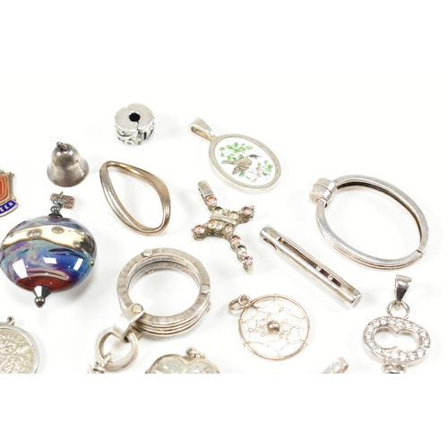 240 - An assorted collection of silver necklace pendants & charms. The lot to include a tubular pendant se... 