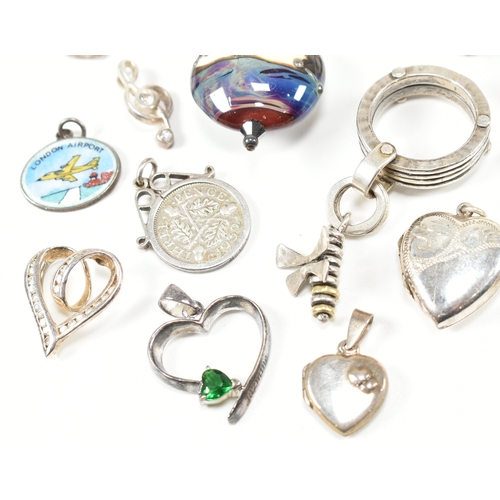 240 - An assorted collection of silver necklace pendants & charms. The lot to include a tubular pendant se... 