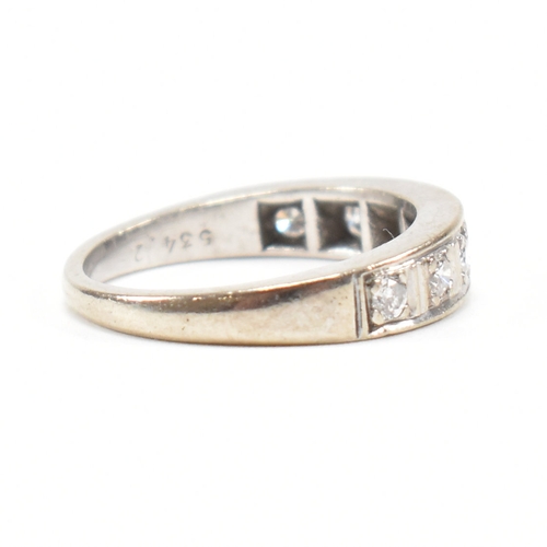 305 - An 18ct white gold and diamond half eternity ring. The ring set with seven round brilliant cut diamo... 