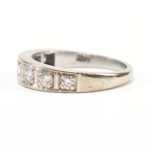 305 - An 18ct white gold and diamond half eternity ring. The ring set with seven round brilliant cut diamo... 