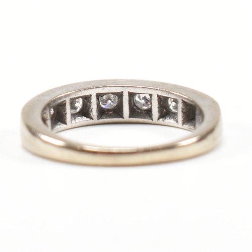 305 - An 18ct white gold and diamond half eternity ring. The ring set with seven round brilliant cut diamo... 