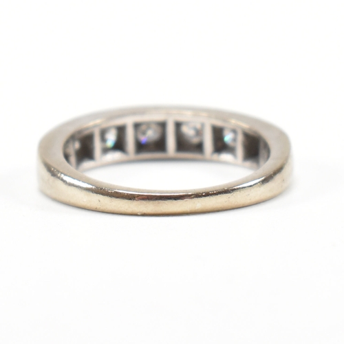 305 - An 18ct white gold and diamond half eternity ring. The ring set with seven round brilliant cut diamo... 