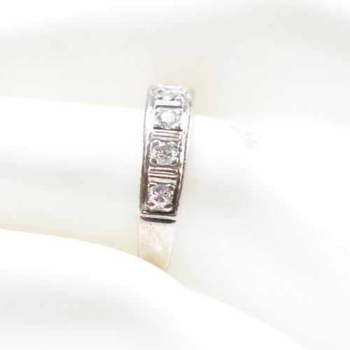 305 - An 18ct white gold and diamond half eternity ring. The ring set with seven round brilliant cut diamo... 