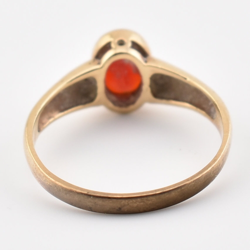 359 - A hallmarked 9ct yellow gold & red stone solitaire ring. The single stone ring having an oval cut be... 