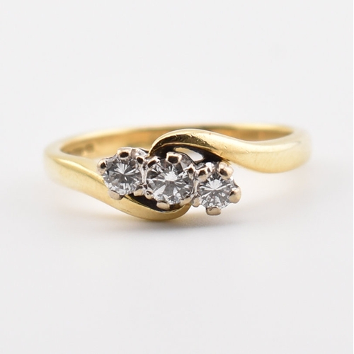 368 - A hallmarked 18ct yellow gold & diamond crossover ring. The ring having three round cut graduating d... 