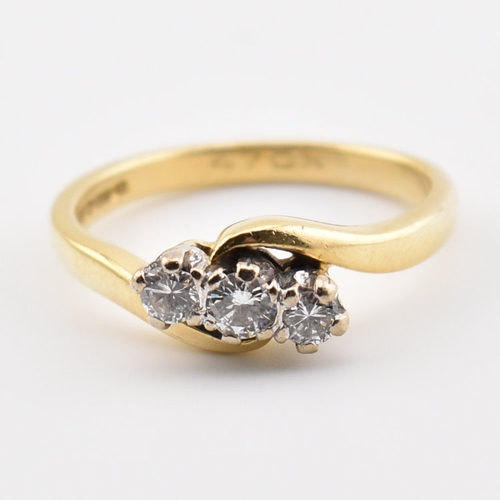 368 - A hallmarked 18ct yellow gold & diamond crossover ring. The ring having three round cut graduating d... 