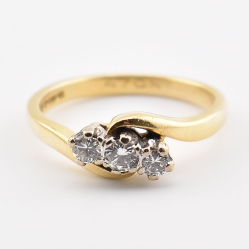 368 - A hallmarked 18ct yellow gold & diamond crossover ring. The ring having three round cut graduating d... 