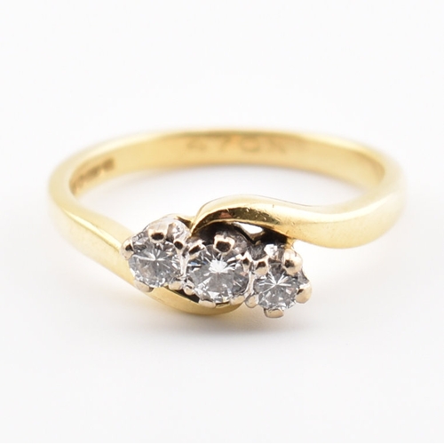 368 - A hallmarked 18ct yellow gold & diamond crossover ring. The ring having three round cut graduating d... 