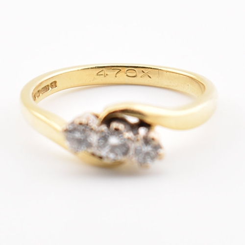 368 - A hallmarked 18ct yellow gold & diamond crossover ring. The ring having three round cut graduating d... 