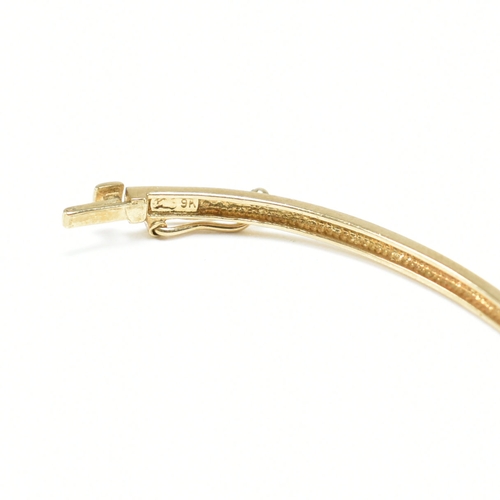 381 - A vintage 9ct yellow gold & white stone bangle bracelet. The hinged half eternity style bangle havin... 