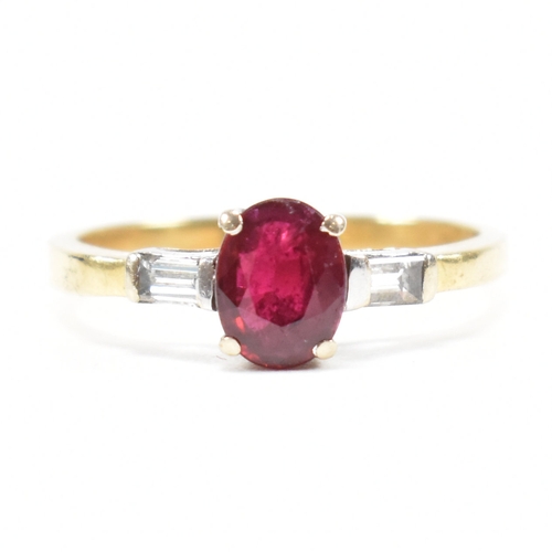 403 - An 18ct gold ruby and diamond ring. The ring set with a central claw mounted ruby and flanked by a p... 