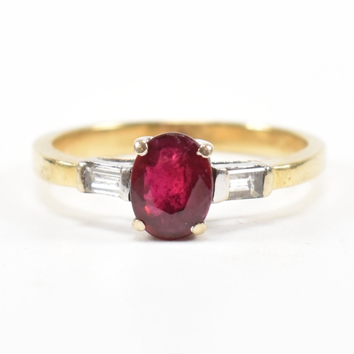 403 - An 18ct gold ruby and diamond ring. The ring set with a central claw mounted ruby and flanked by a p... 