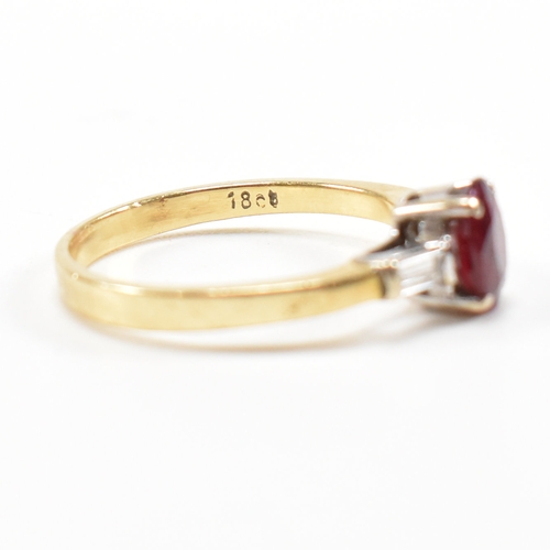 403 - An 18ct gold ruby and diamond ring. The ring set with a central claw mounted ruby and flanked by a p... 