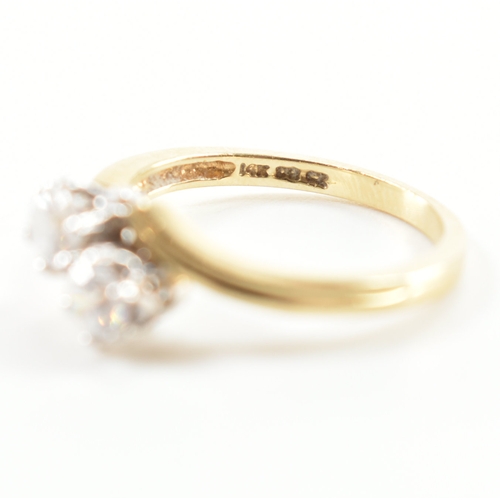 419 - Two 14ct gold and cz dress rings. The lot to include a two stone crossover ring hallmarked London, s... 