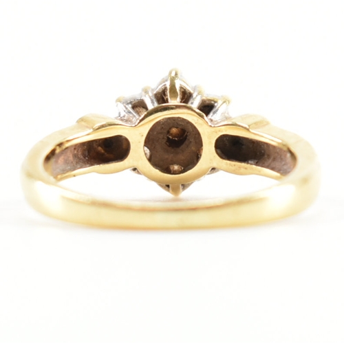 440 - A hallmarked 18ct gold and diamond cluster ring. The ring being set with a cluster of round cut diam... 