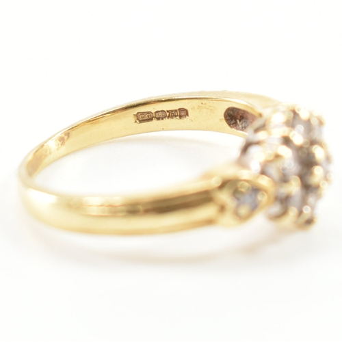 440 - A hallmarked 18ct gold and diamond cluster ring. The ring being set with a cluster of round cut diam... 