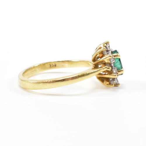 460 - An 18ct gold emerald and diamond cluster ring.  The ring set with a central oval cut emerald framed ... 