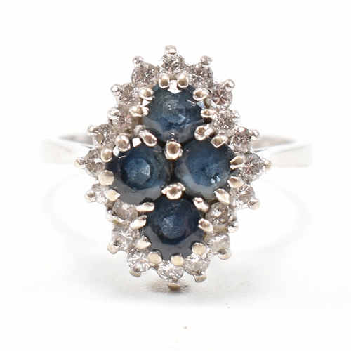 462 - A hallmarked 18ct gold sapphire and diamond cluster ring. The ring set with four round mixed cut sap... 