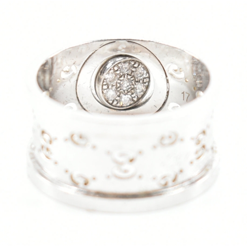 469 - A Gucci hallmarked 18ct white gold & diamond ring. The ring having a central circular swivel head se... 